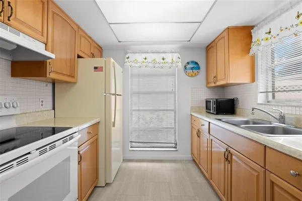 a kitchen with a refrigerator and a sink