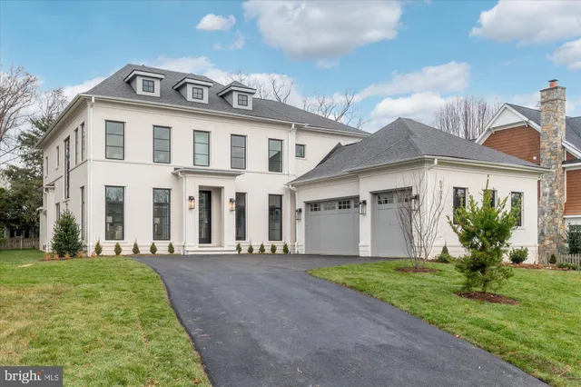 a front view of a house with a garden and yard