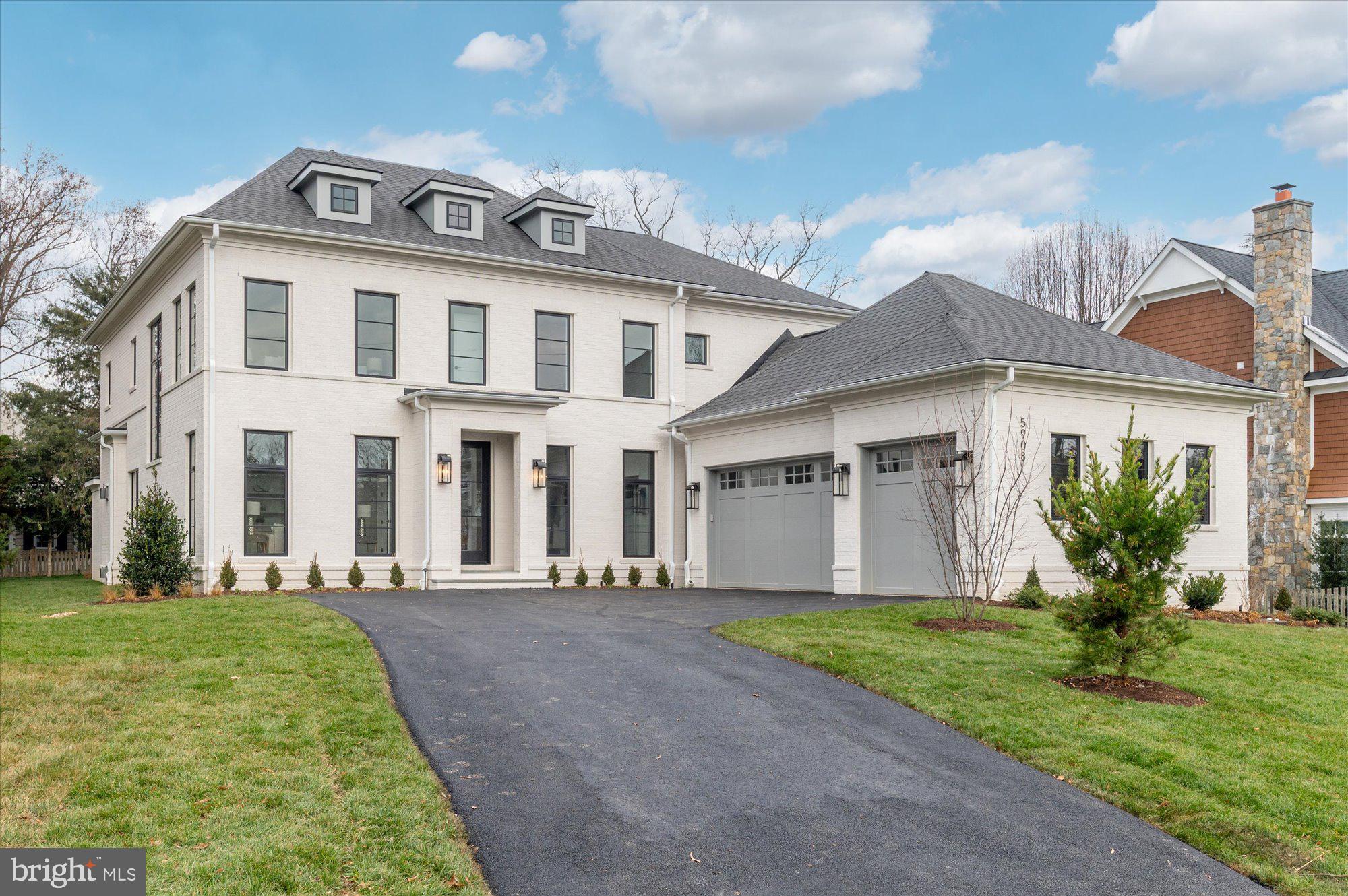 a front view of a house with a garden and yard