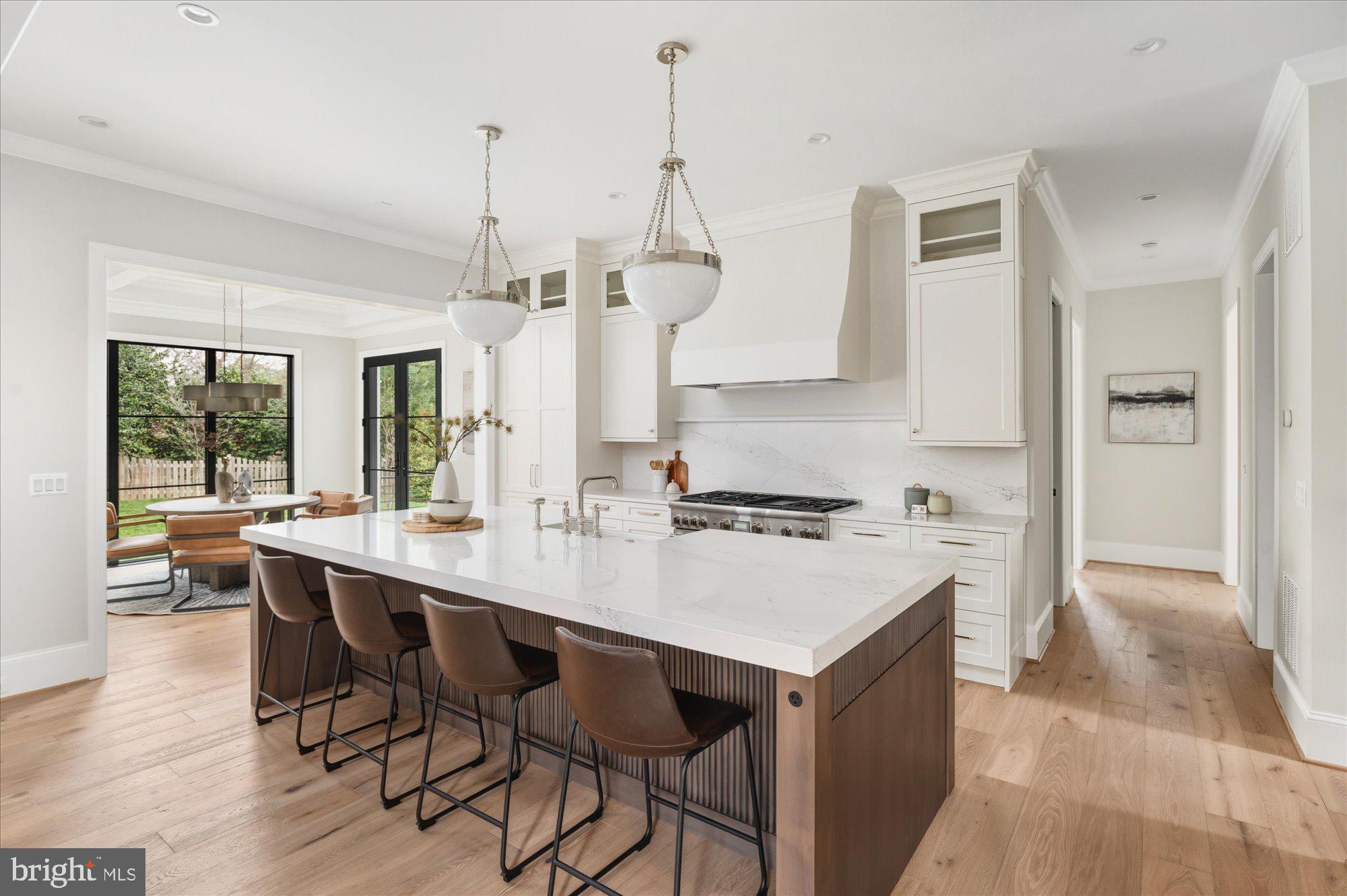 5908 Calla Drive McLean, VA 22101 - Photo 16 of 66 a kitchen with a sink a stove a dining table and chairs