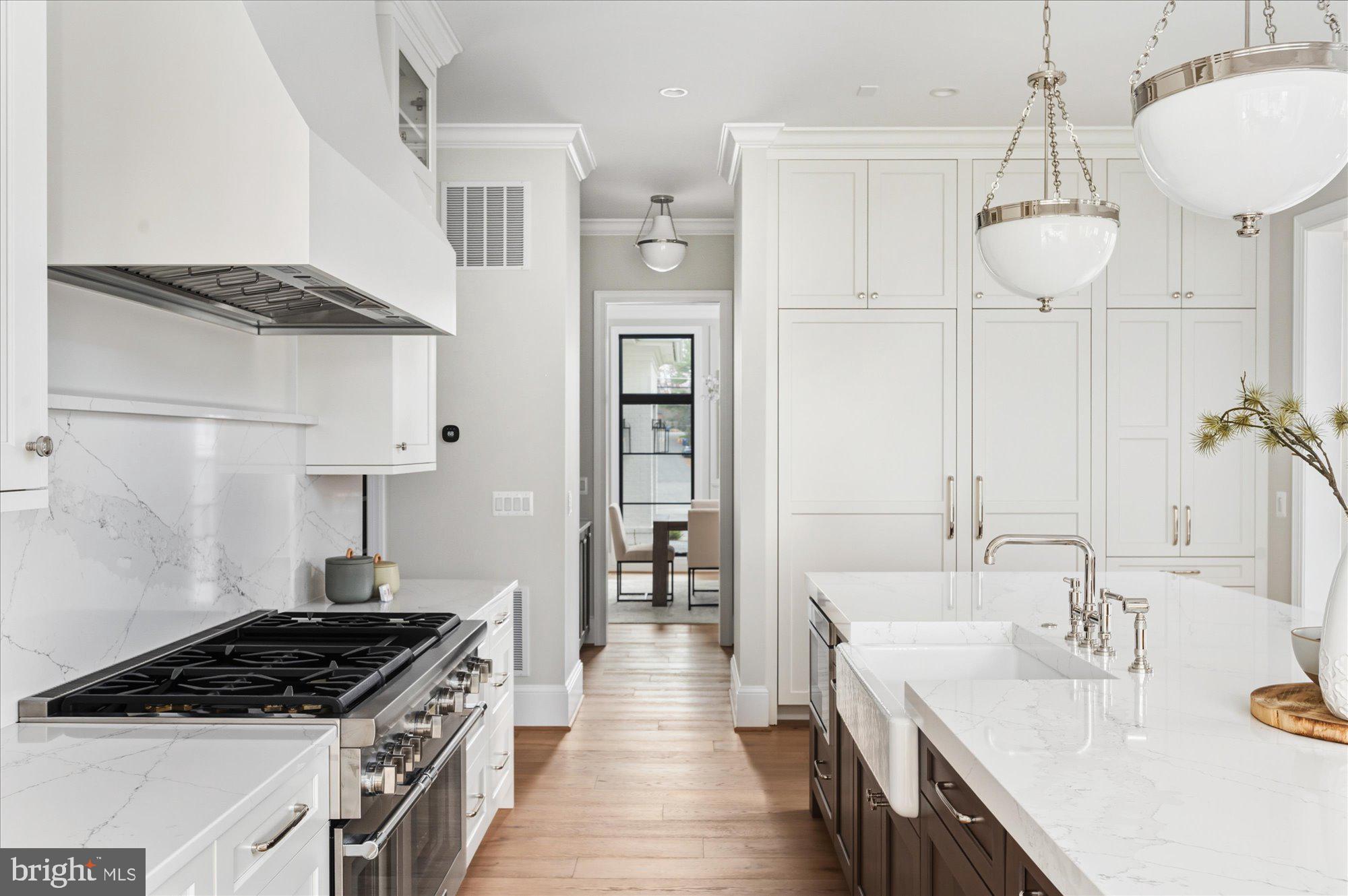 5908 Calla Drive McLean, VA 22101 - Photo 18 of 66 a kitchen with stainless steel appliances granite countertop a sink stove and refrigerator