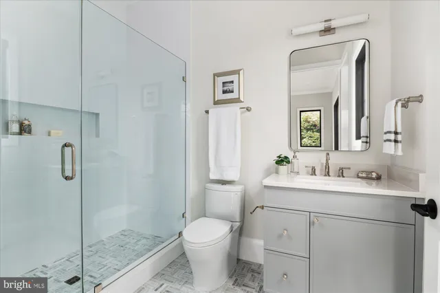 a living room with furniture large window and wooden floor