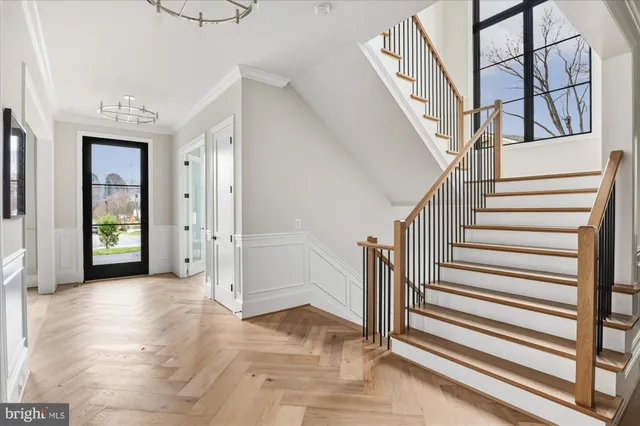 a living room with furniture wooden floor and a large window