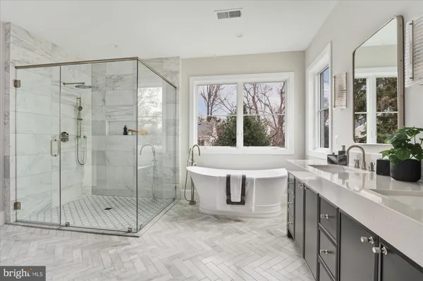 a bathroom with a sink a mirror a toilet and a bathtub