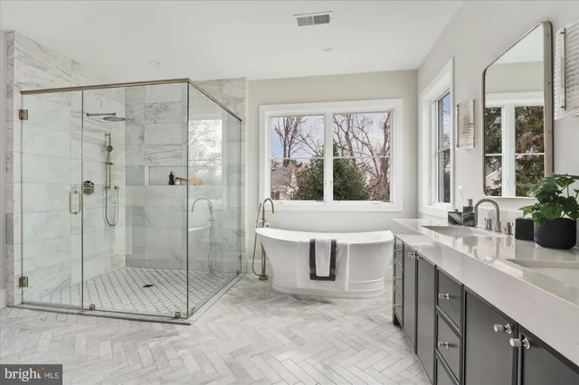 a bathroom with a sink a mirror a toilet and a bathtub