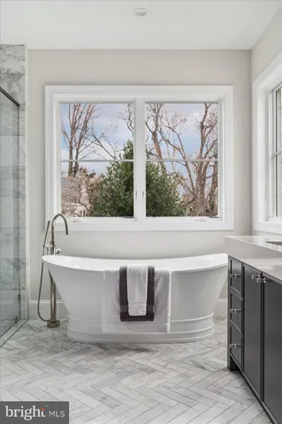 a view of an empty room with a fireplace and a window