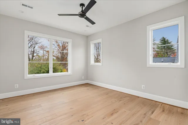 a living room with patio furniture and a flat screen tv