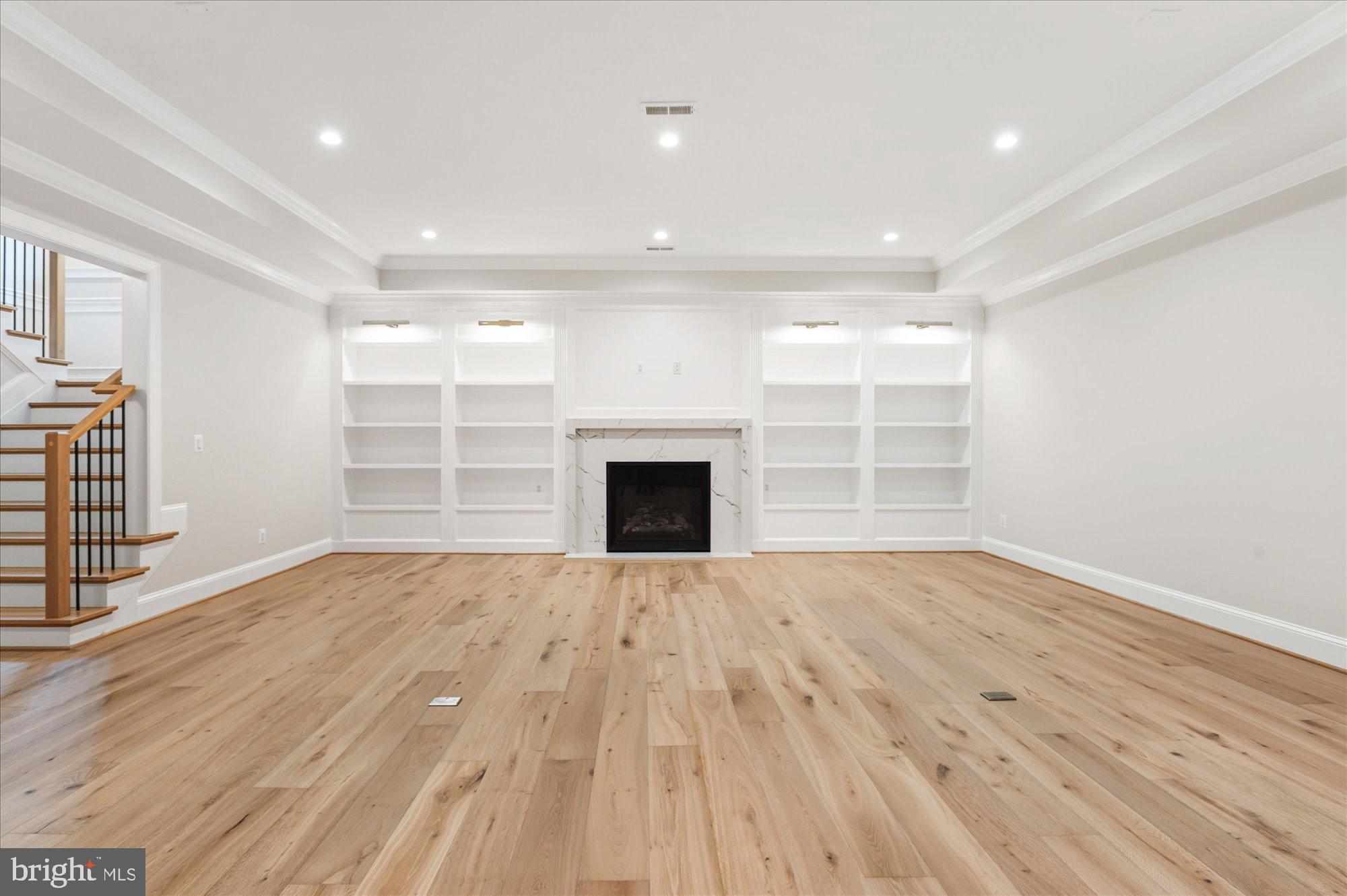 5908 Calla Drive McLean, VA 22101 - Photo 51 of 66 an empty room with wooden floor and fireplace