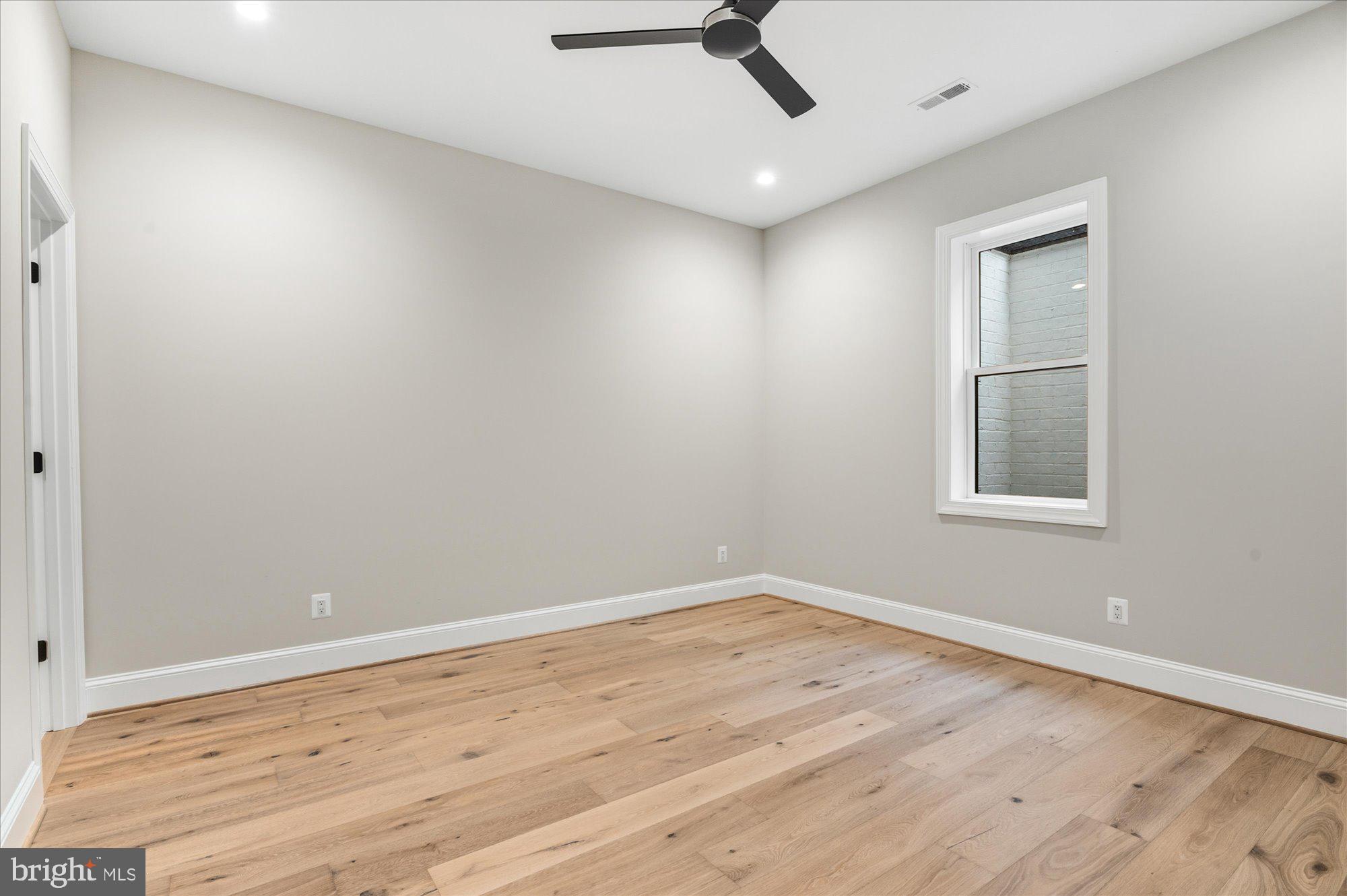 5908 Calla Drive McLean, VA 22101 - Photo 57 of 66 an empty room with a window and ceiling fan