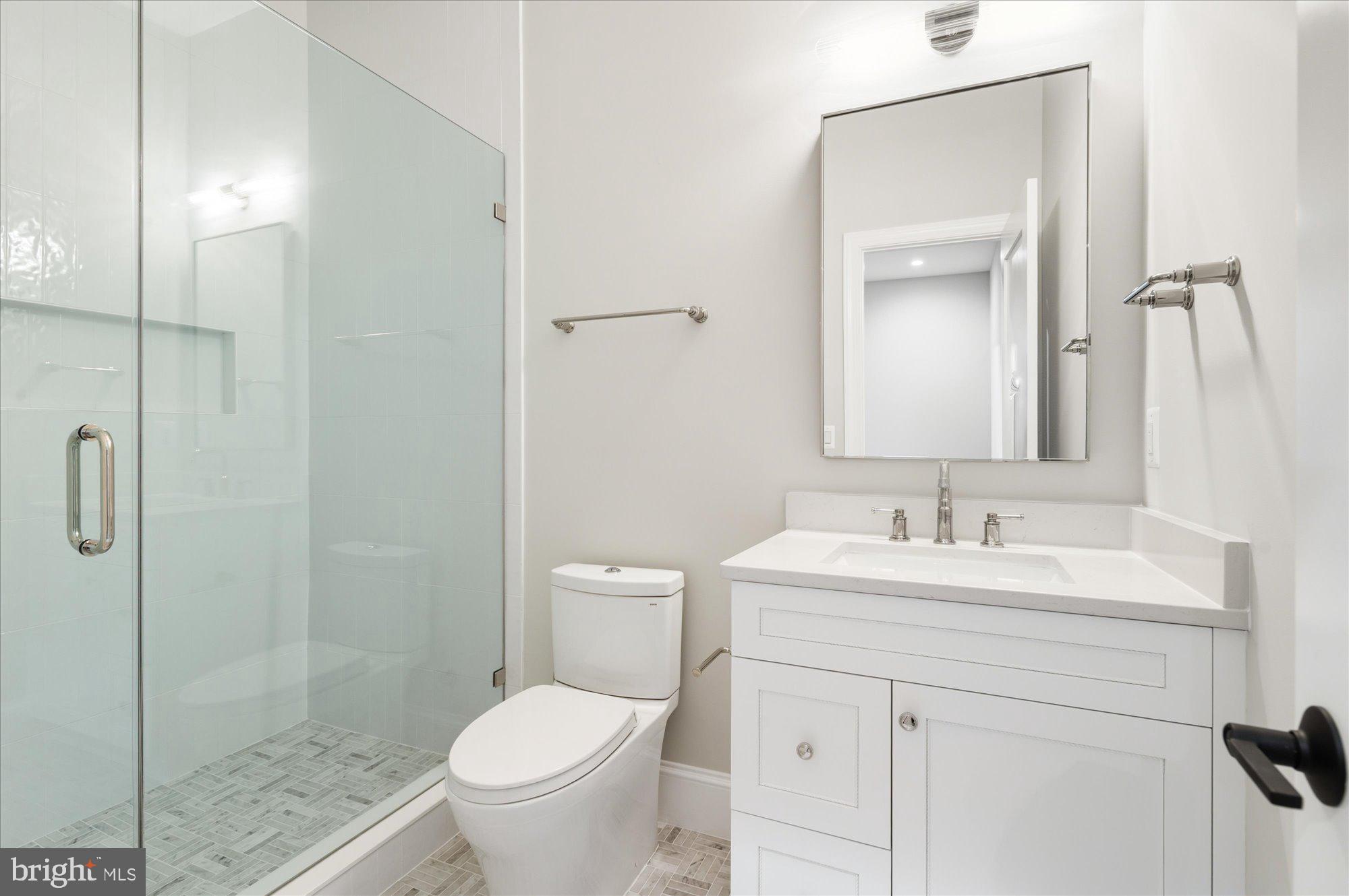 5908 Calla Drive McLean, VA 22101 - Photo 58 of 66 a bathroom with a toilet sink vanity and mirror