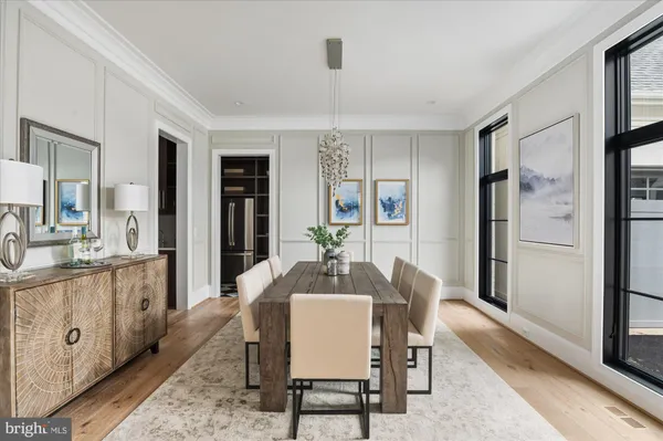 a dining room with furniture and wooden floor