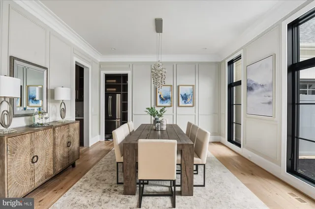 a dining room with furniture and wooden floor