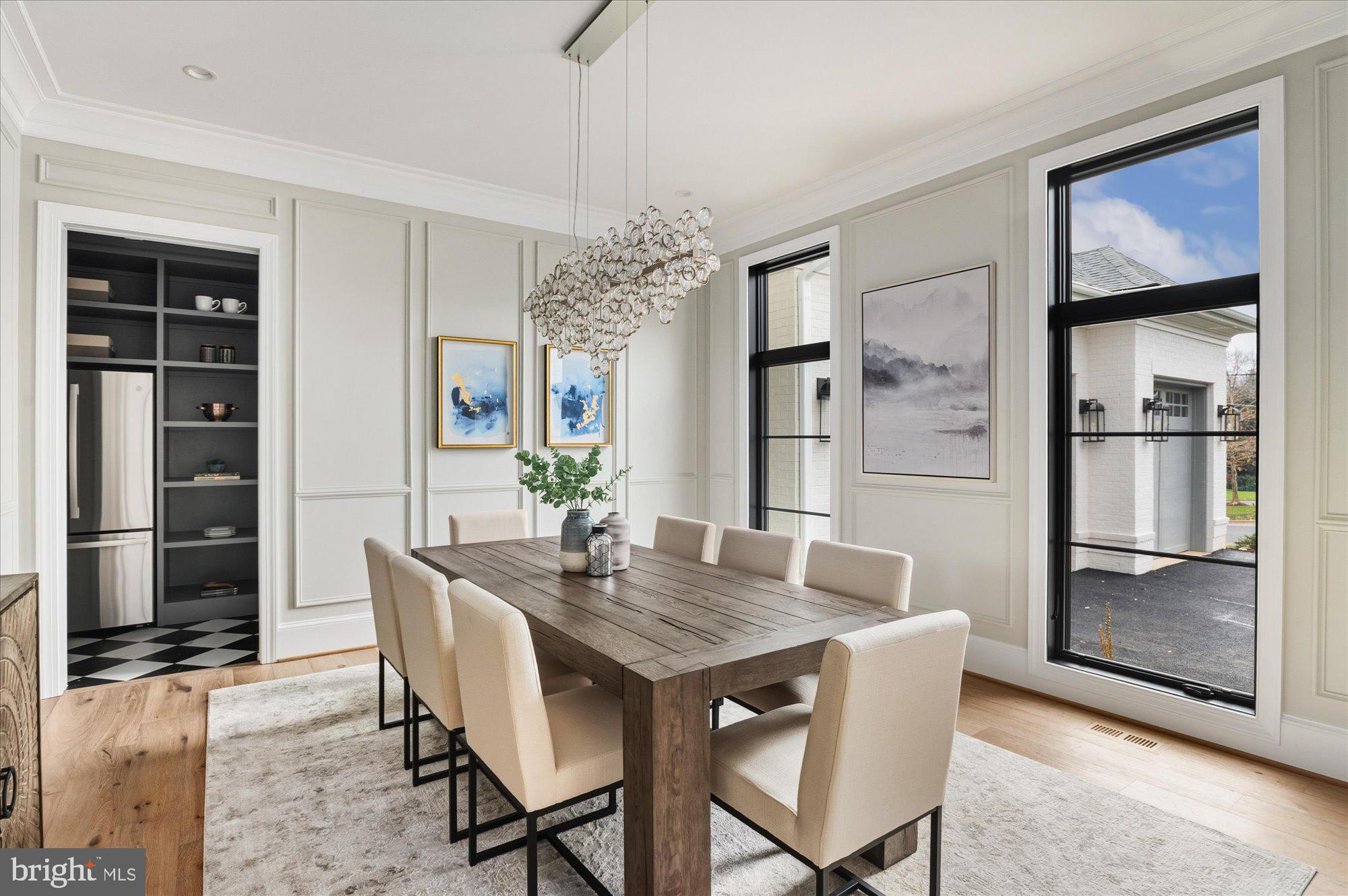 5908 Calla Drive McLean, VA 22101 - Photo 8 of 66 a dining room with furniture a chandelier and wooden floor