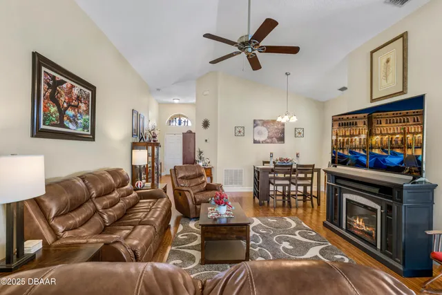 a living room with furniture a rug and a lamp
