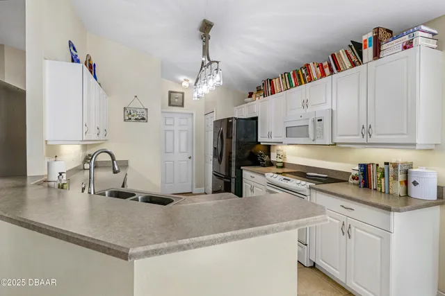 a kitchen with stainless steel appliances granite countertop a refrigerator a stove a sink and dishwasher
