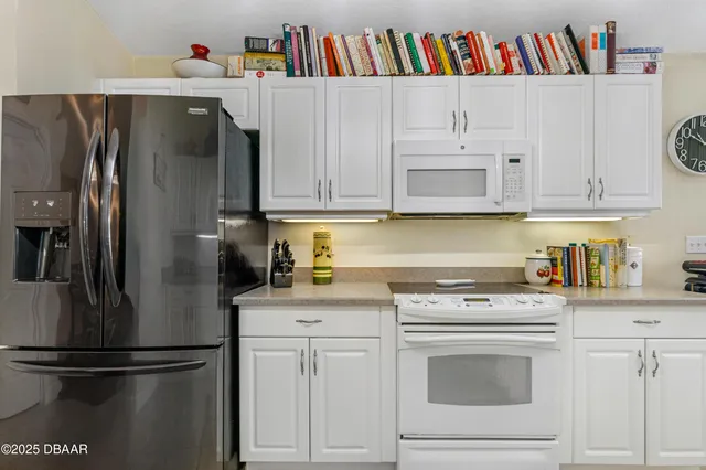 a kitchen with cabinets and white appliances