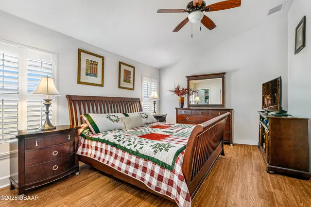 a bedroom with a bed and wooden floor