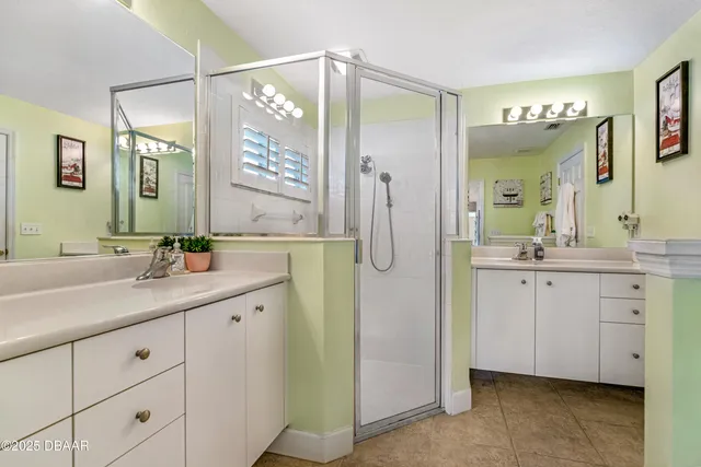 a bathroom with a granite countertop sink a mirror and a next to a window