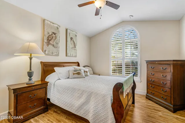 a bedroom with a bed and a painting on the wall