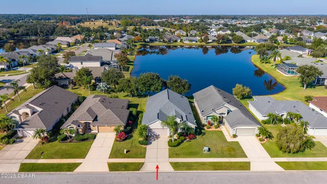 an aerial view of residential houses with outdoor space and street view
