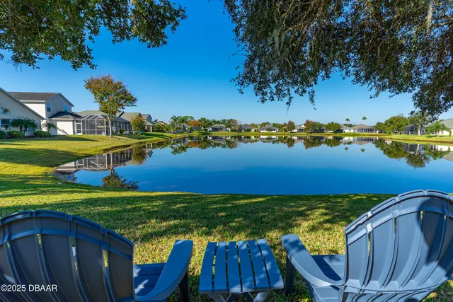 a front view of house with yard and outdoor seating