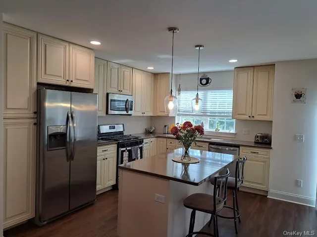 a kitchen with refrigerator cabinets dining table and chairs