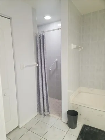 a bathroom with a shower and a sink