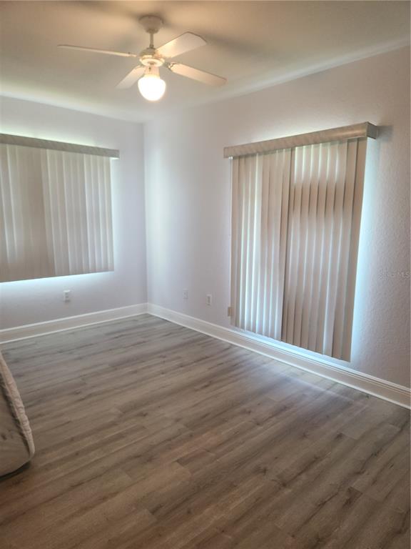 26270 Explorer Road Punta Gorda, FL 33983 - Photo 6 of 22 a view of an empty room with wooden floor and a window