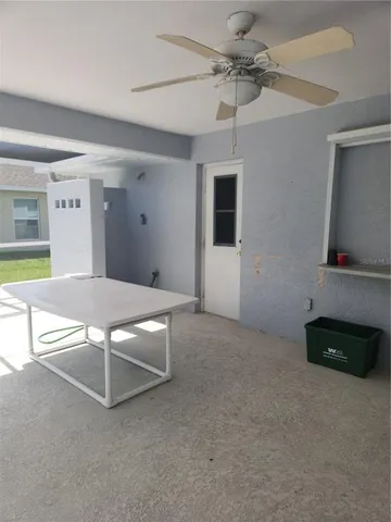 a living room with stainless steel appliances kitchen island granite countertop furniture and a flat screen tv