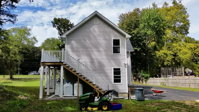 a view of a house with backyard and sitting area