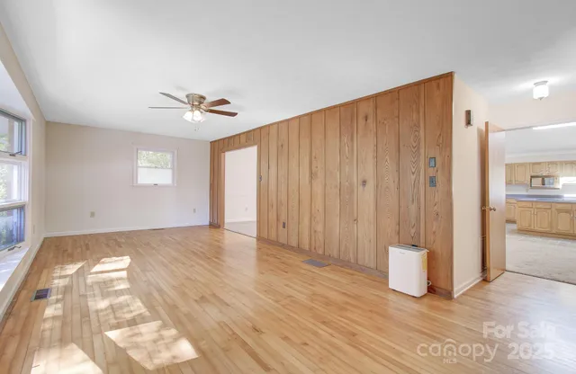 a view of an empty room with a fireplace and a window