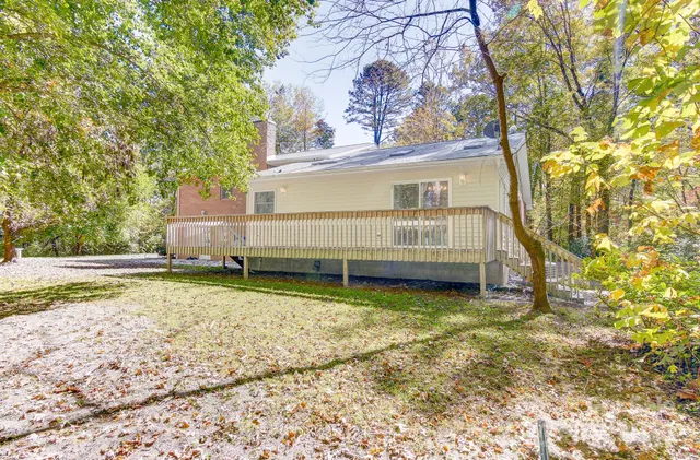 a view of balcony with wooden floor and fence
