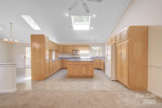 a large kitchen with a large window and stainless steel appliances
