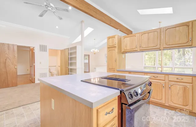 a kitchen that has a sink and a view of living room