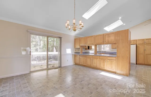 a view of a kitchen with refrigerator a sink and dishwasher with a large window