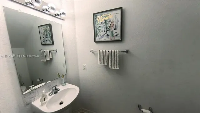 a bathroom with a sink and mirror