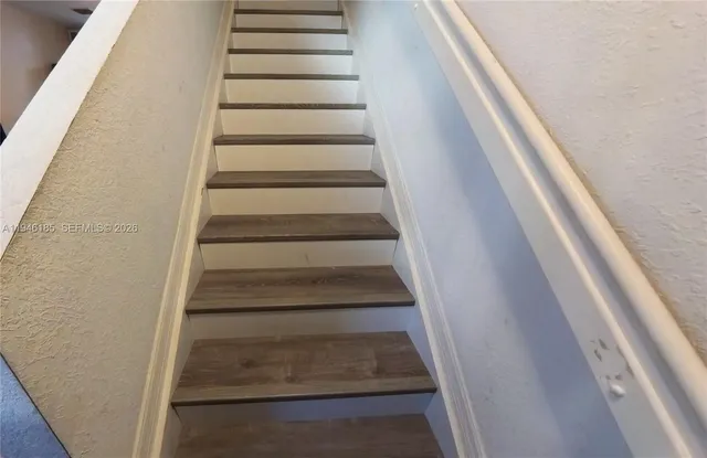 a view of staircase with white walls