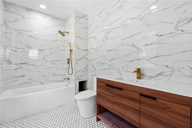 a bathroom with a bathtub and a toilet