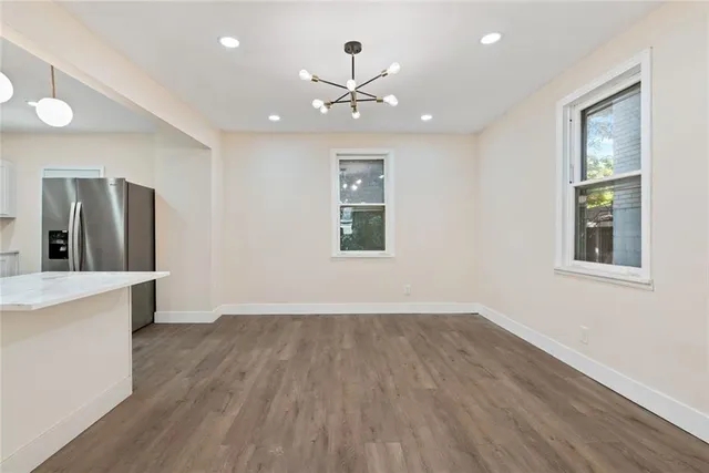 a view of a kitchen with wooden floor and a window
