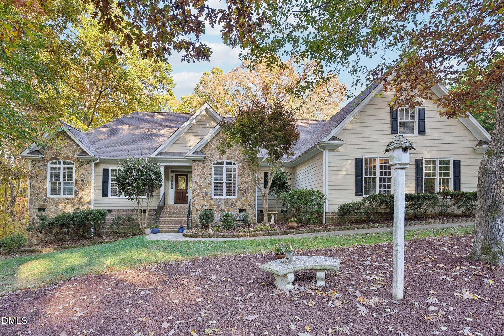 a front view of house with yard and green space