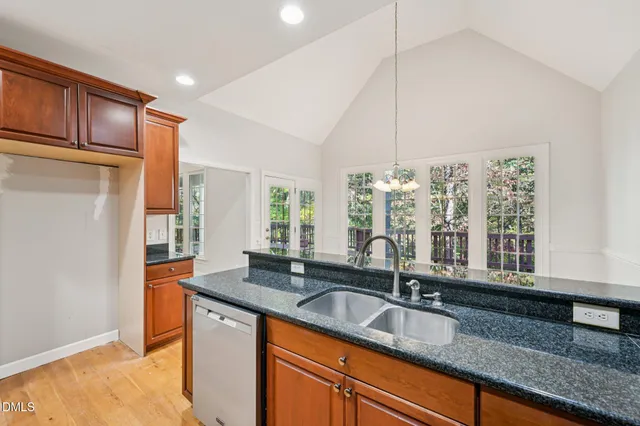 a kitchen with granite countertop a sink and a window