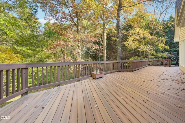 a view of balcony with wooden floor and fence