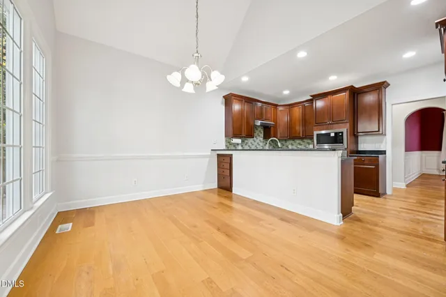a view of a kitchen with a sink a refrigerator and a window