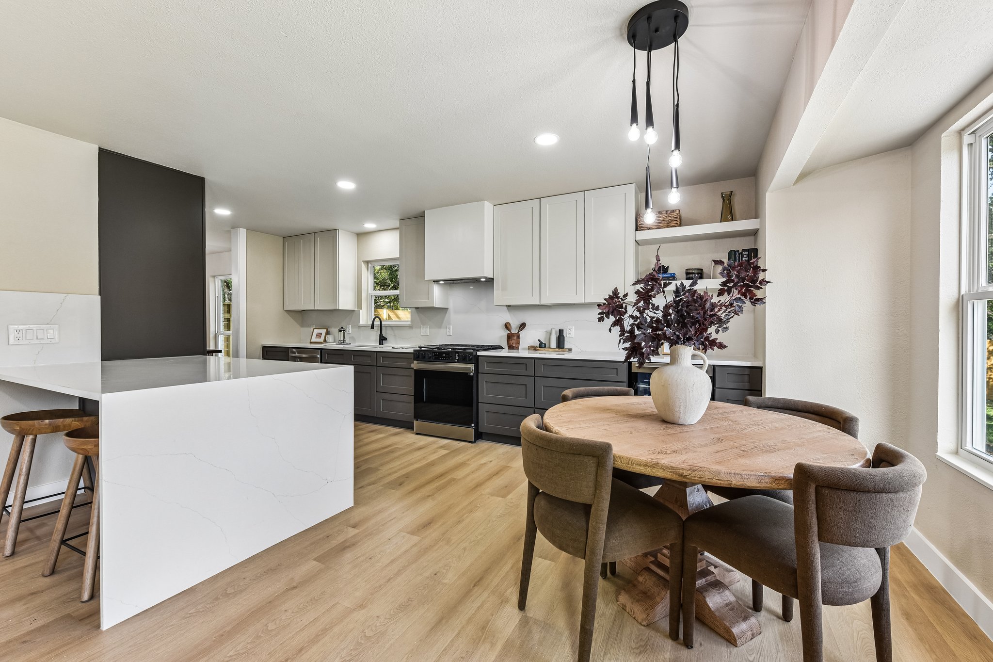 7523 Glenhill Road Austin, TX 78752 - Photo 13 of 38 A well-lit kitchen with a modern design, featuring a large island and ample cabinet space.