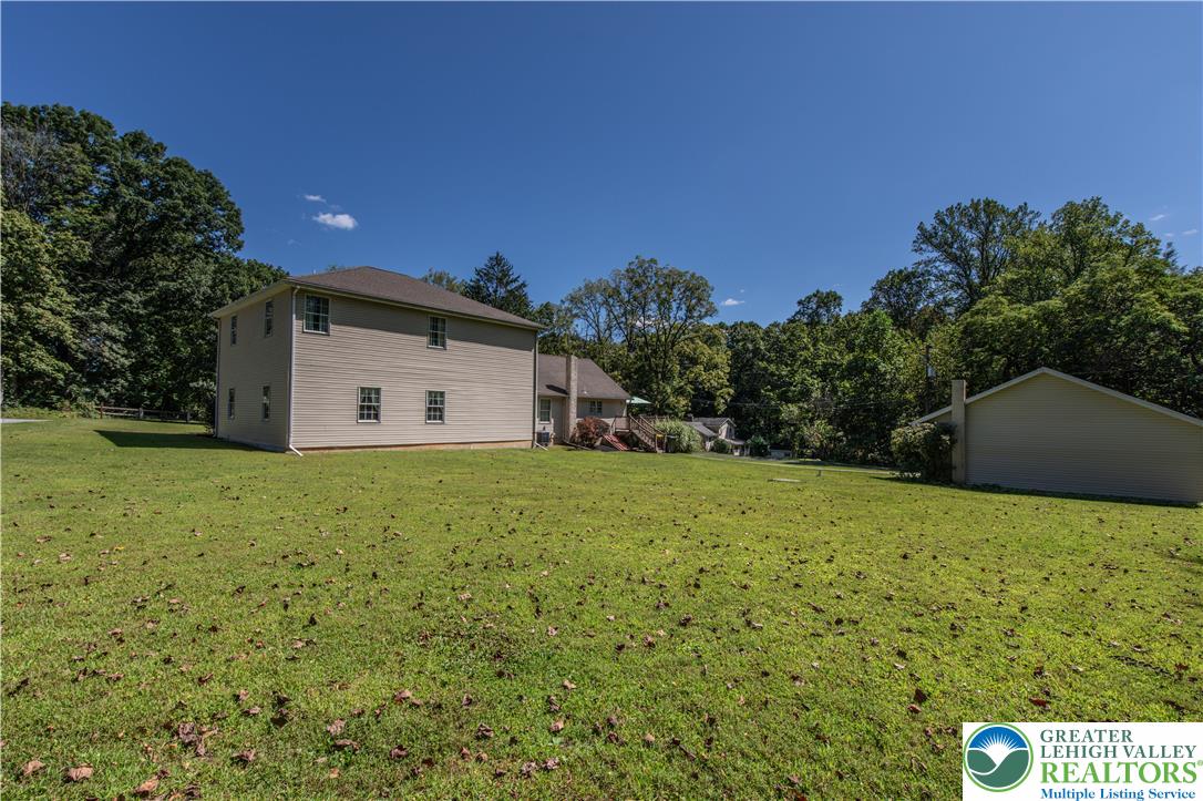 3256 Woodlea Road Orefield, PA 18069 - Photo 11 of 43 a view of a backyard with plants and large trees