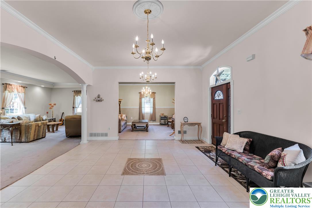 3256 Woodlea Road Orefield, PA 18069 - Photo 18 of 43 a living room with furniture and a chandelier