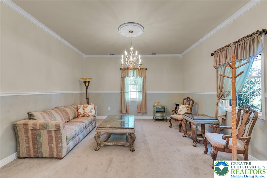 3256 Woodlea Road Orefield, PA 18069 - Photo 21 of 43 a living room with furniture chandelier and a large window