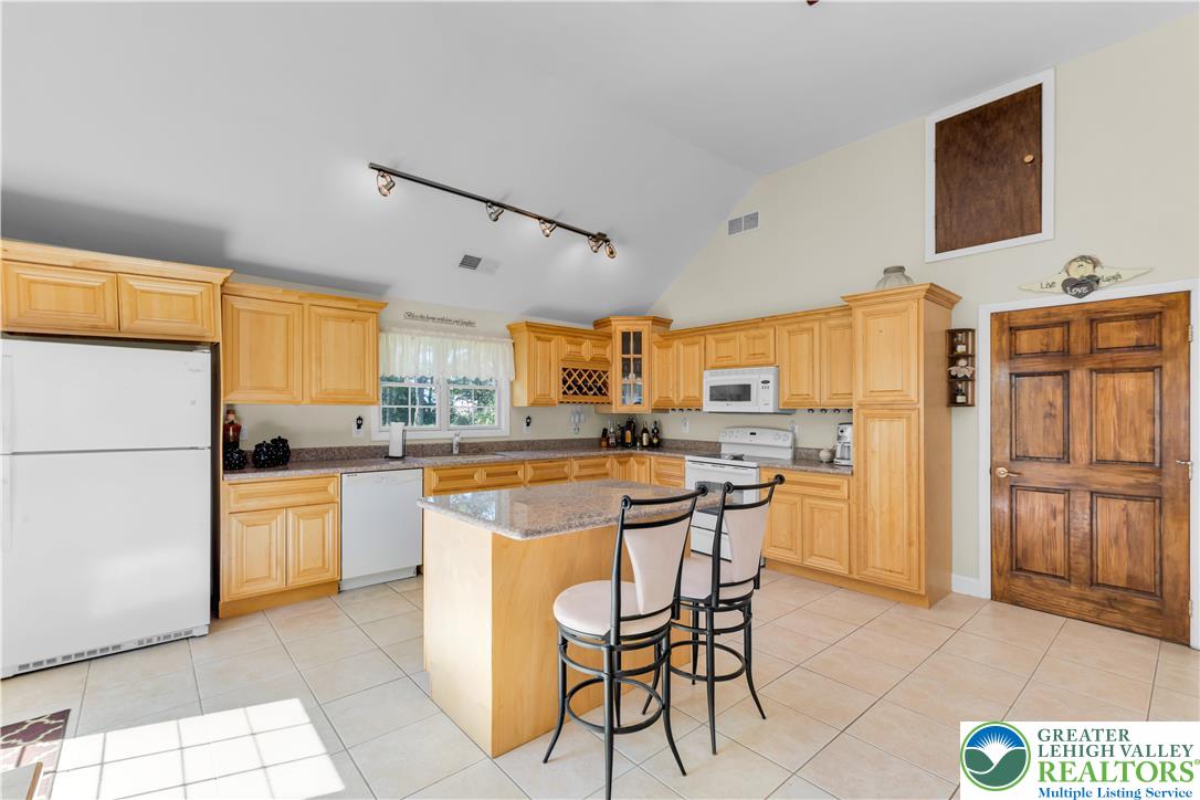 3256 Woodlea Road Orefield, PA 18069 - Photo 28 of 43 a kitchen with stainless steel appliances a stove a refrigerator and a stove top oven