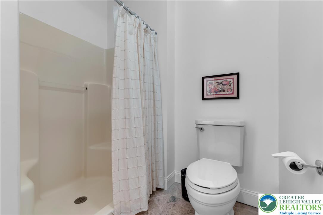 3256 Woodlea Road Orefield, PA 18069 - Photo 29 of 43 a white toilet sitting next to a shower