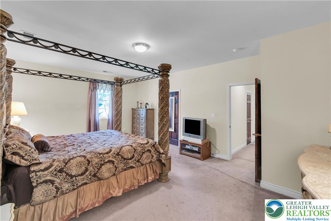 3256 Woodlea Road Orefield, PA 18069 - Photo 34 of 43 a bedroom with a bed couch and a window